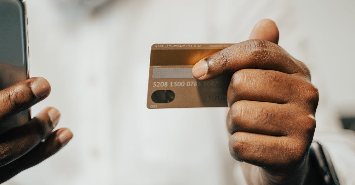 Are MasterCard and Visa accepted by Amsterdam taxis? - Person Holding Brown Magnetic Card