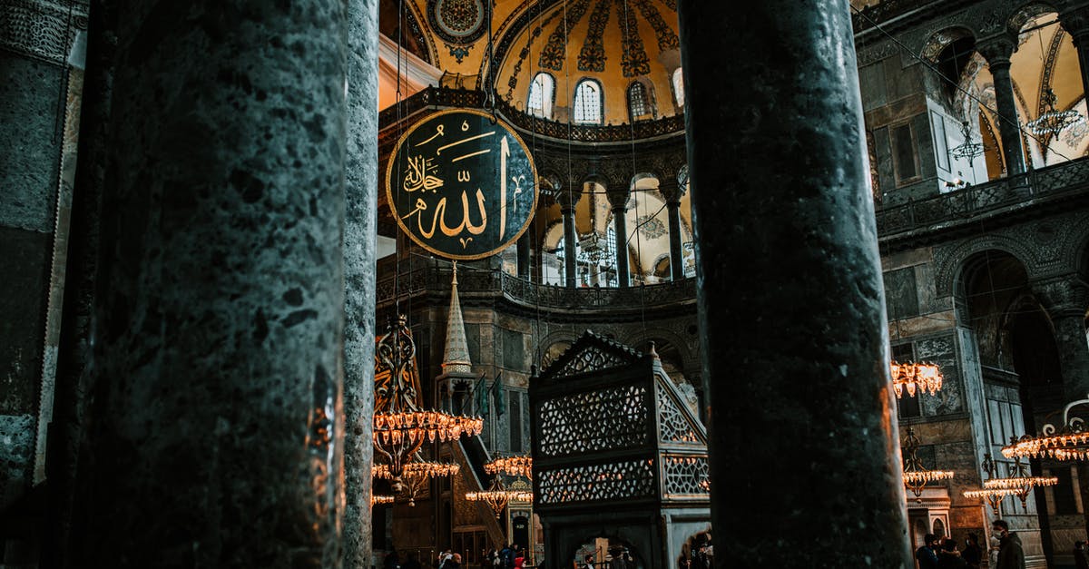 Are non-Muslims allowed to visit the Prophet's Mosque in Medina? - Interior of aged mosque with columns and rich decorated walls