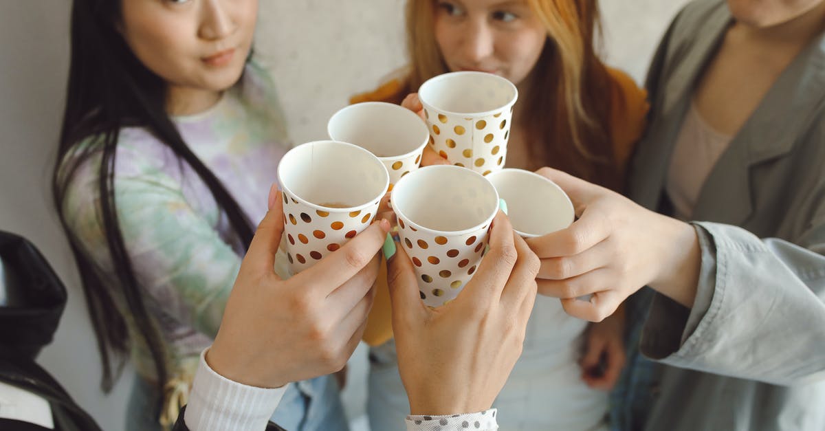 Are people in Hungary and Slovakia friendly? [closed] - Woman Holding White and Black Polka Dot Ceramic Mug