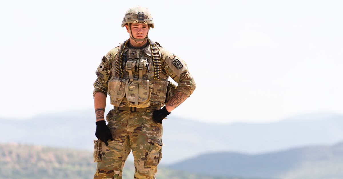 Are replica unarmed explosives allowed in hand luggage? - Unarmed US Soldier in Field Camo Uniform with Mountains in Background