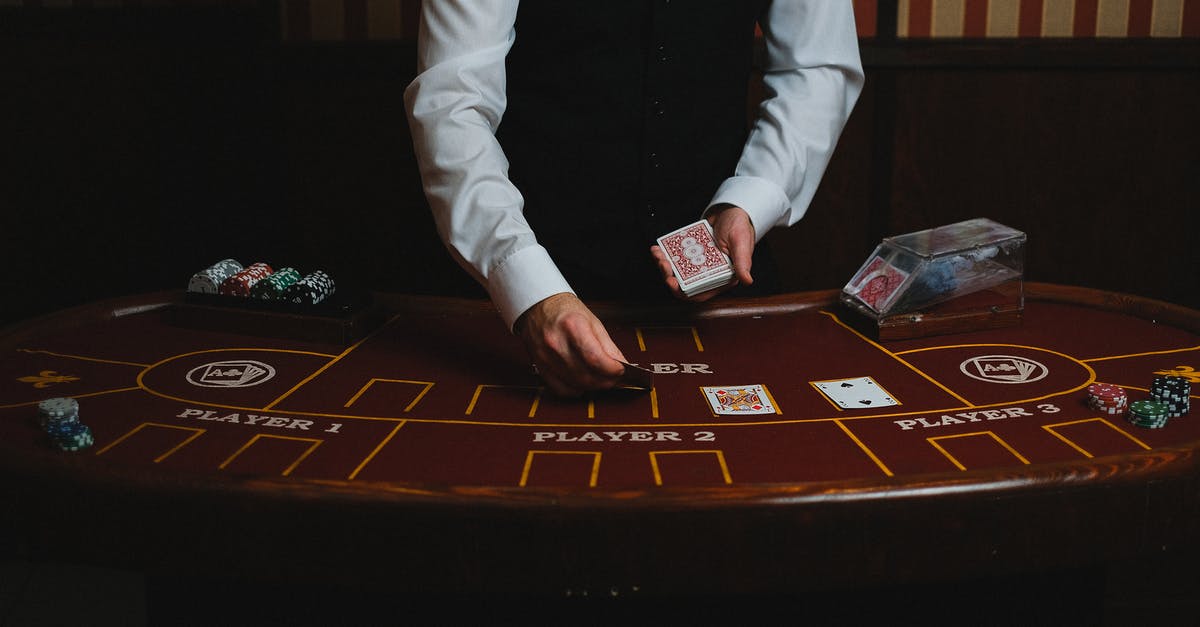 Are San Francisco Muni tokens still valid? - Man in White Suit Jacket Sitting Beside Brown Wooden Table