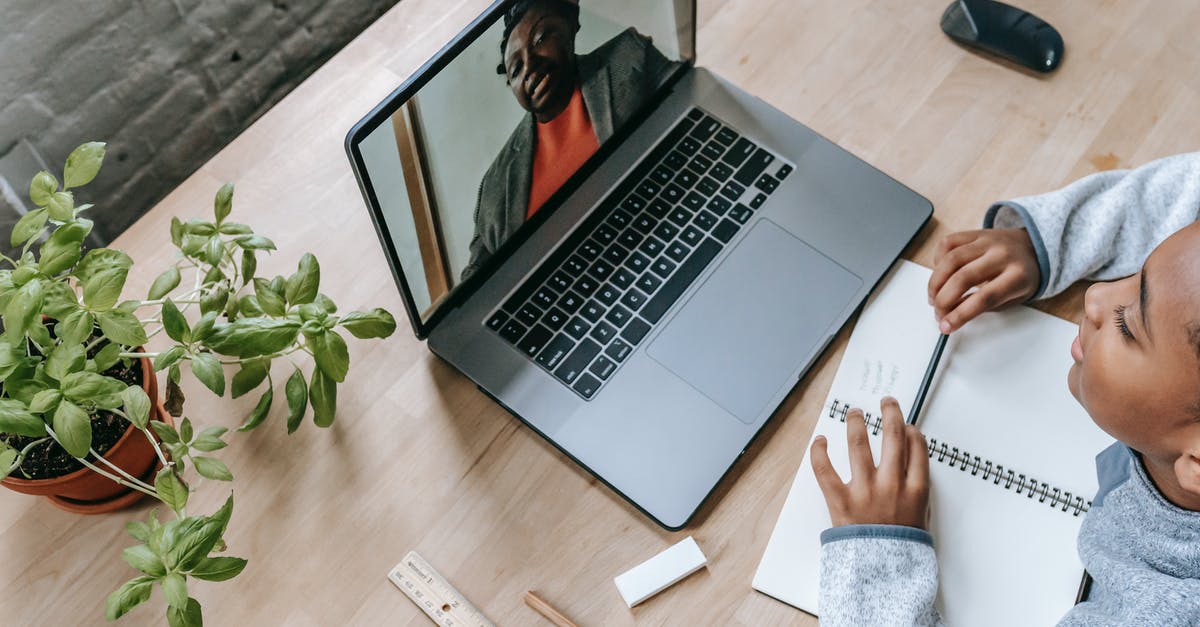 Are self-administered COVID tests valid for Singapore pre-entry purposes? - Top view of adorable intelligent African American boy preparing for exam with tutor through internet on latop