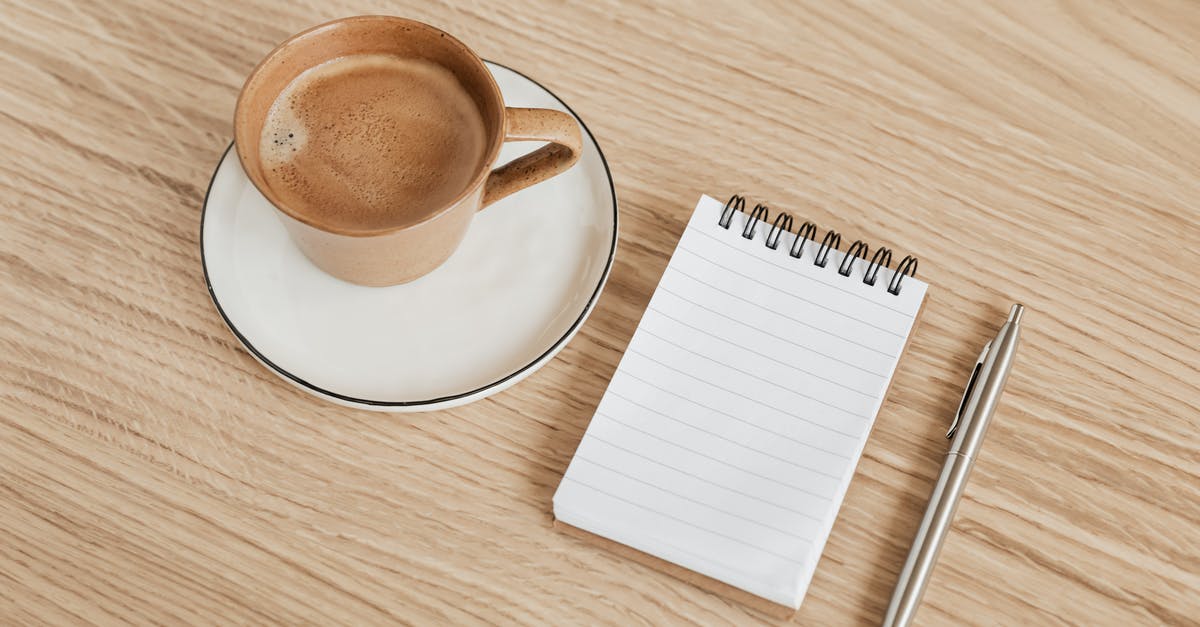 Are shops in Slovakia open on 15. August? - From above of ceramic cup of hot espresso on white saucer placed near opened ring bound notebook and stylish silver pen on wooden surface