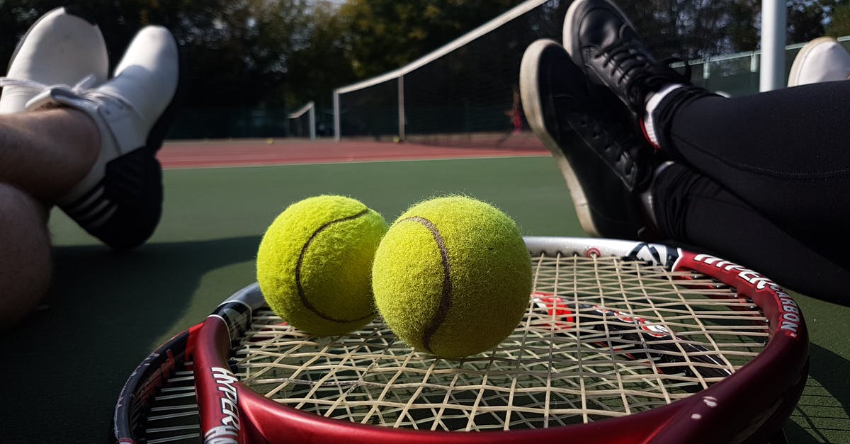 Are tennis rackets allowed in airplane cabins in the US? - Close-Up Photograph of Tennis Balls on Top of Tennis Rackets