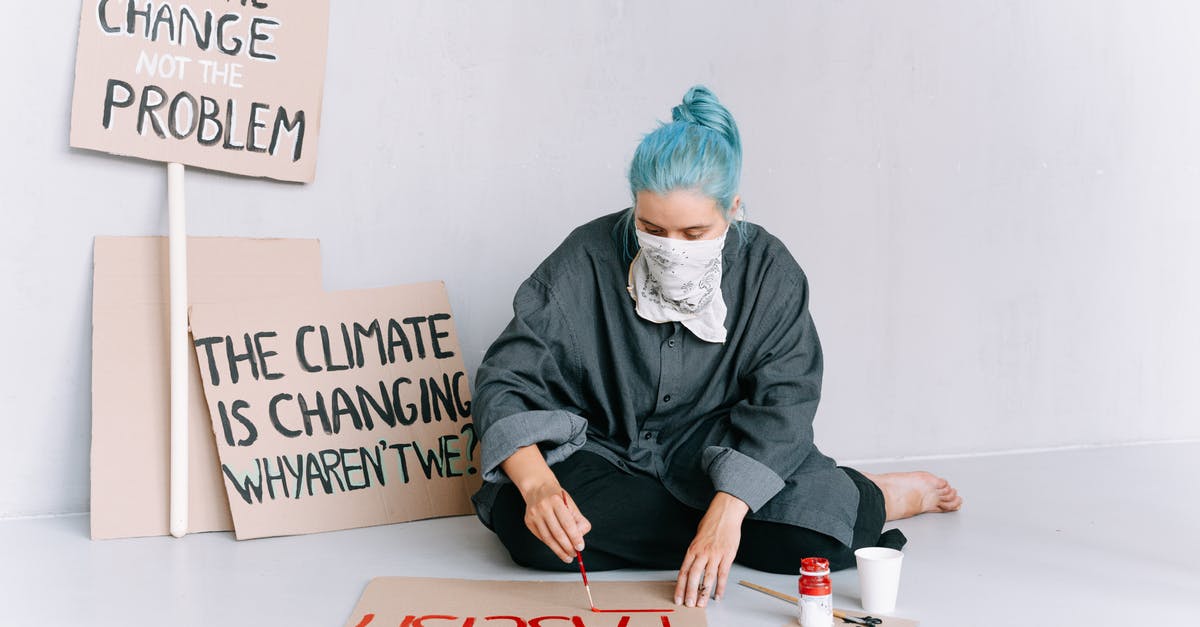 Are the Finnish and Udmurt languages mutually intelligible? - A Woman Sitting on the Floor Writing Protests on a Placard