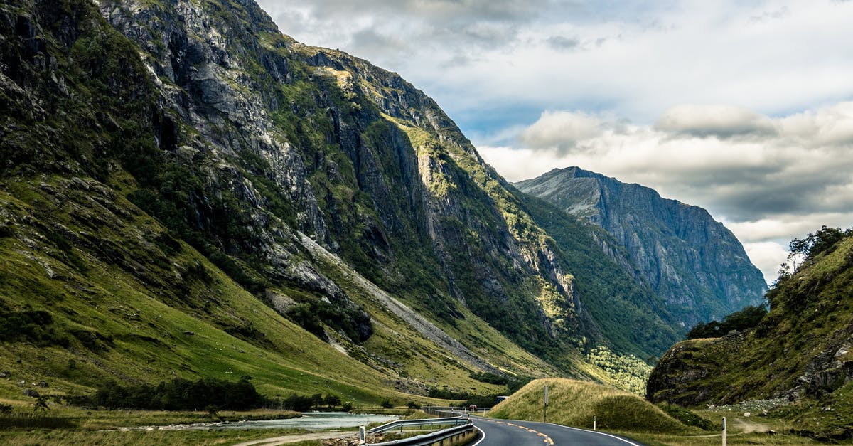 Are the roads in Norway in good condition? - Gray Asphalt Road Between Mountains