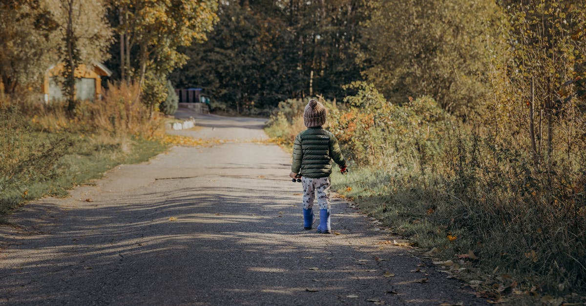 Are the roads in Norway in good condition? - Boy Walking on Road