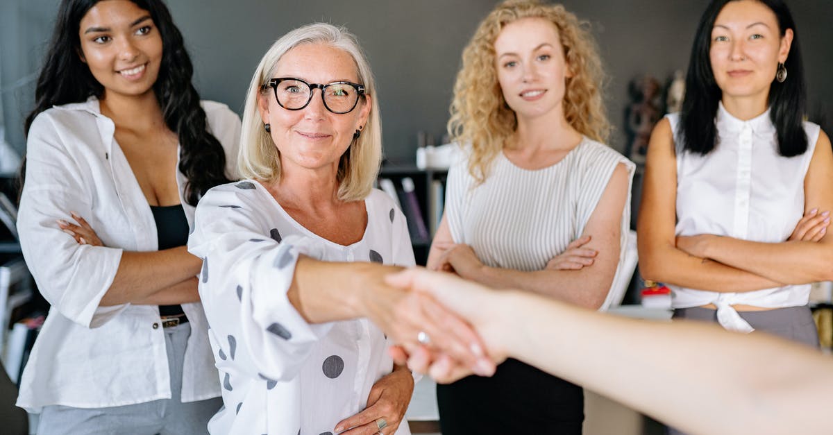 Are there any alternatives to the handshake worldwide? - Woman in White Sleeveless Shirt Wearing Eyeglasses