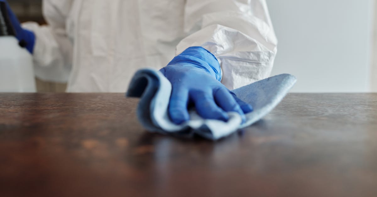 Are there any countries that exempt people who recovered from COVID-19 infection from quarantine or testing? - Close-Up Photo Of Person Cleaning The Table