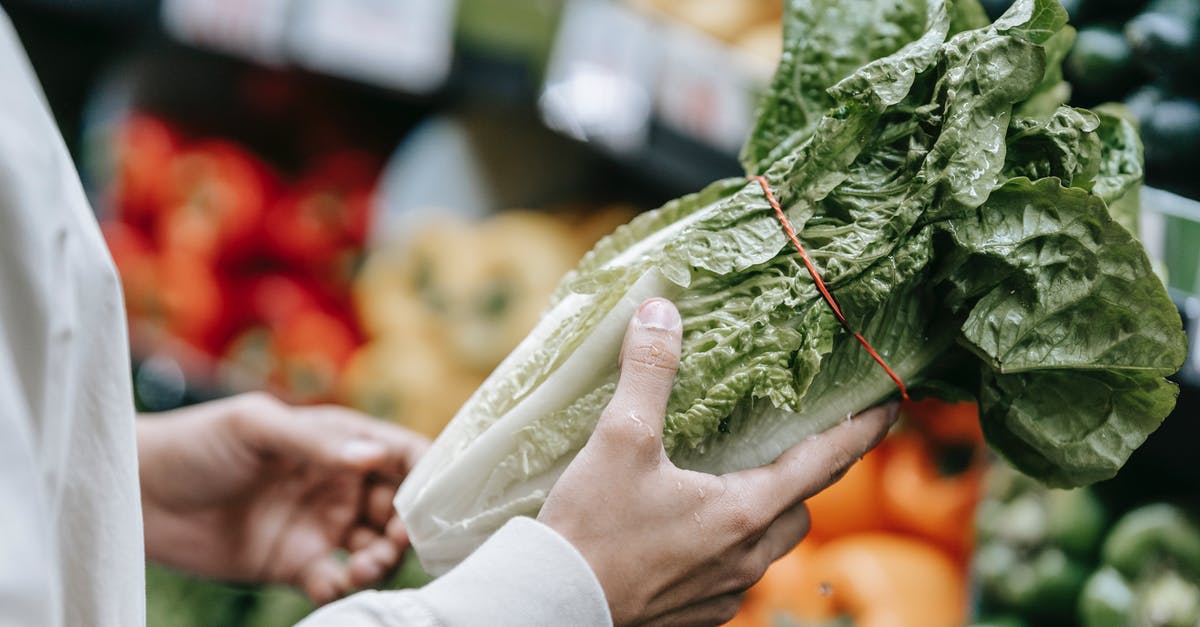 Are there any department stores in Salzburg? - Unrecognizable customer with fresh lettuce