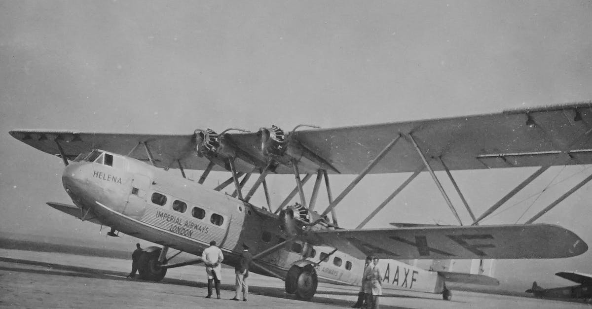 Are there any flights from London to Blackpool? - Grayscale Photo of Airplane on the Ground With Men Looking