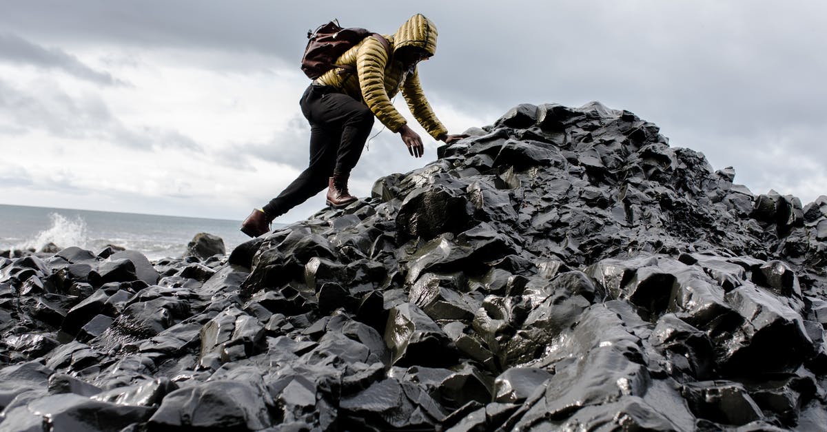 Are there any hiking challenges around Quebec City? [closed] - Man Wearing Hoodie and Black Pants Climbing Up Pile of Rocks