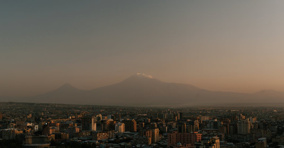 Are there any inhabited condominiums (joint sovereignties) apart from Brčko District? - From above of high towers located in city against high rocky top in evening