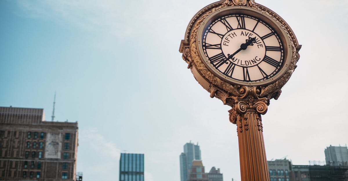 Are there any inhabited condominiums (joint sovereignties) apart from Brčko District? - From below of aged metal clock tower located in city center with high towers