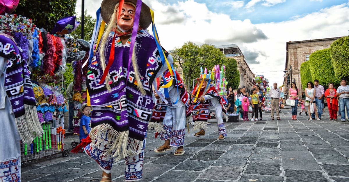 Are there any legal restrictions on busking in Mexico City? - Person in Traditional Dress at the Street