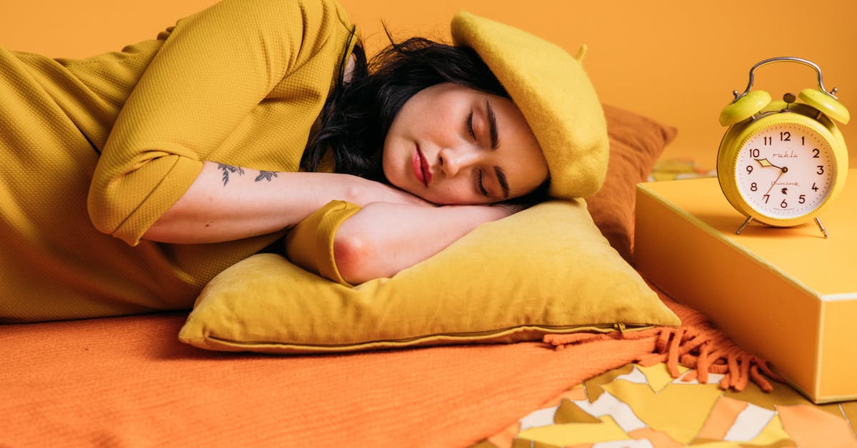 Are there any lightweight travel alarm clocks? - A Sleeping Woman In Yellow Outfit 