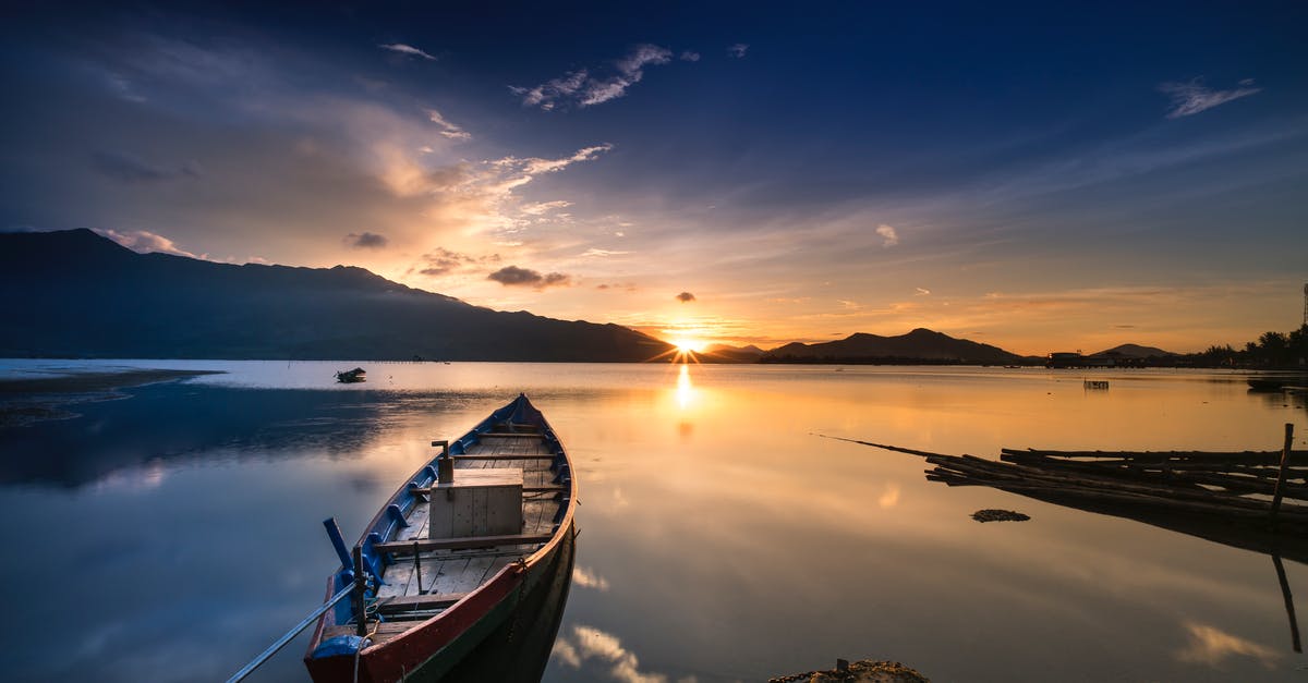 Are there any natural lakes within 3-hours of Dallas? - Empty Gray Canoe Boat Near Shore during Golden Hour