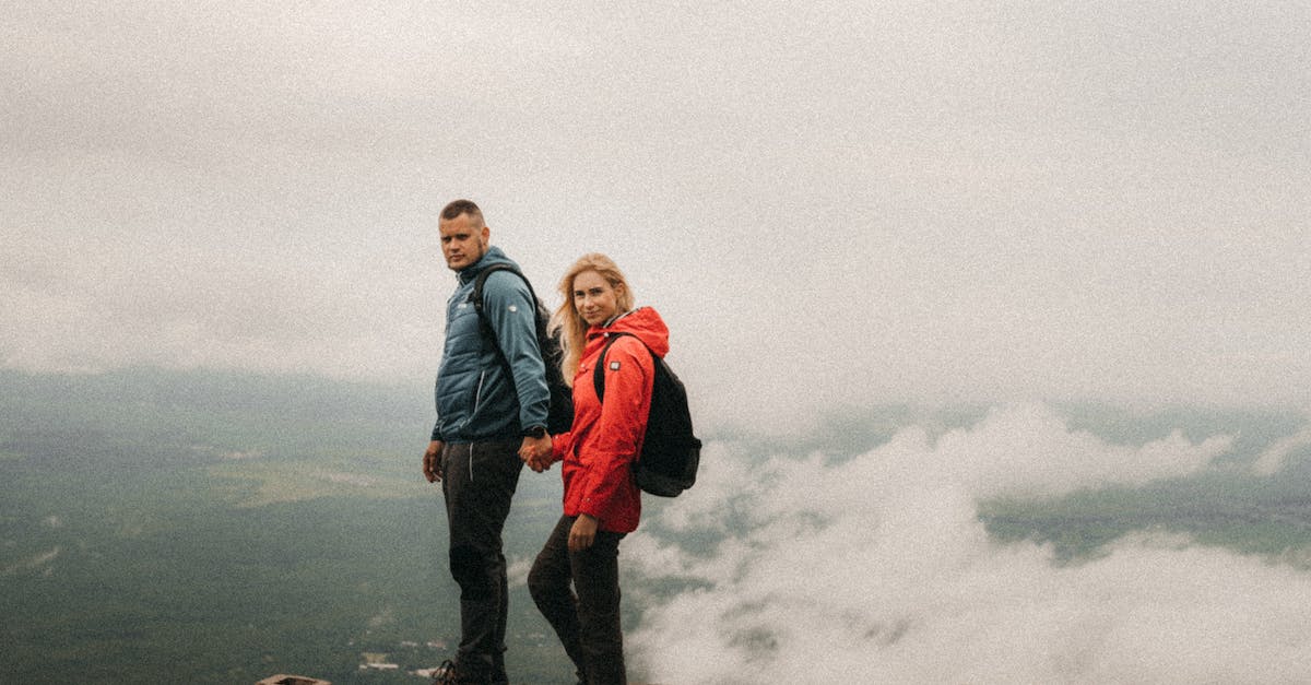 Are there any perks/discounts for travelling as a couple on Air France? - Side view of young travelers with rucksacks looking at camera on building roof under cloudy sky