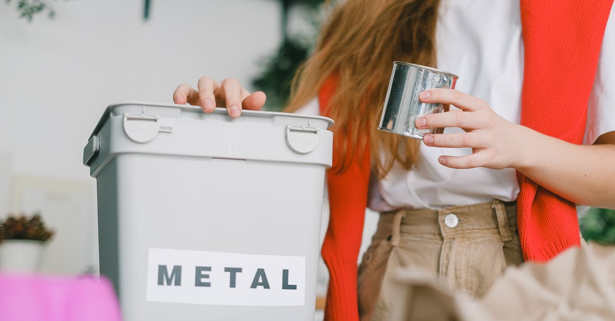 Are there any prepaid cards that can be used in Russia? - Low angle of female putting tin can into bucket for metal trash for recycling litter