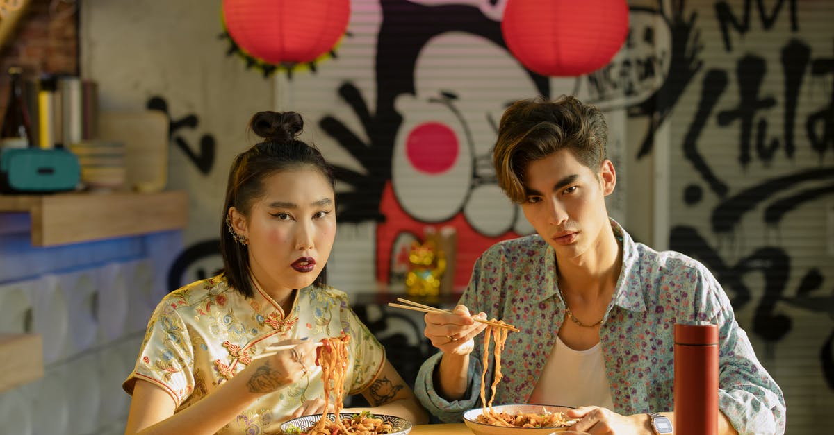 Are there any restaurants serving real chinese food in Benelux? [closed] - Couple Eating Bowl of Noodles