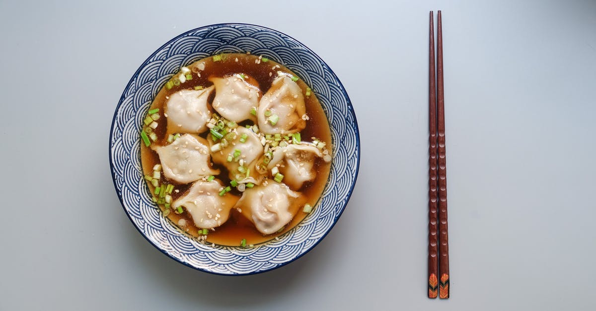 Are there any soup kitchens or food pantries in Tromsø? - Round White and Blue Ceramic Bowl With Cooked Ball Soup and Brown Wooden Chopsticks