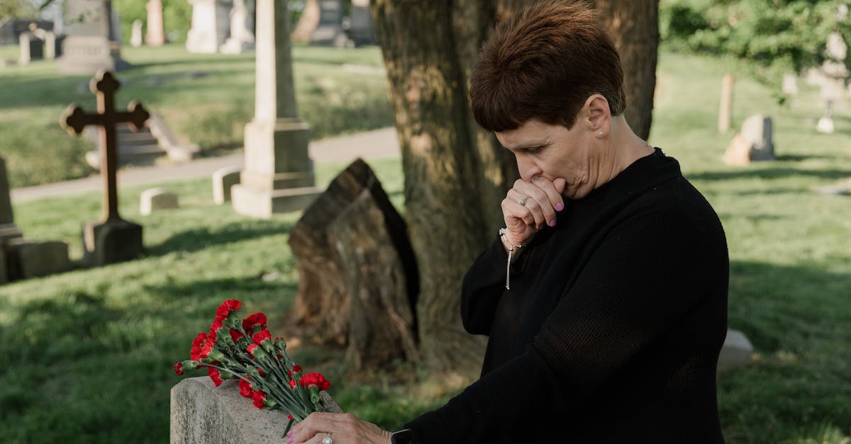 Are there any standard clothing restrictions when visiting mosques? - A Woman Holding Flowers at the Cemetery