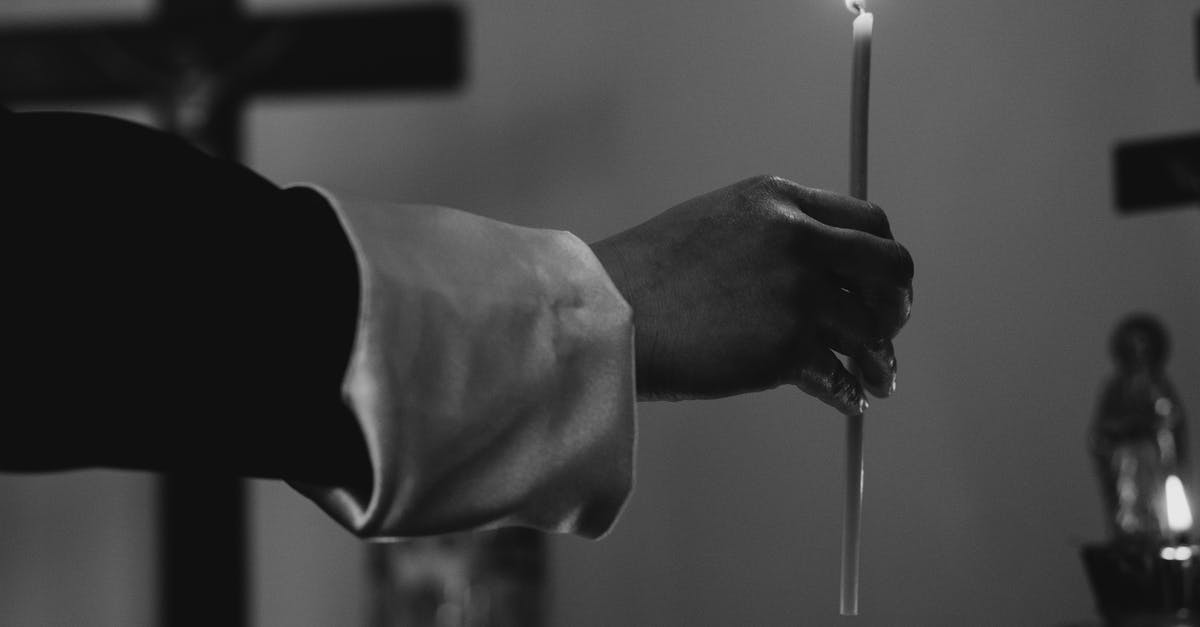 Are there any Taizé worship services in Helsinki? - Grayscale Photo of Person Holding Lighted Candle