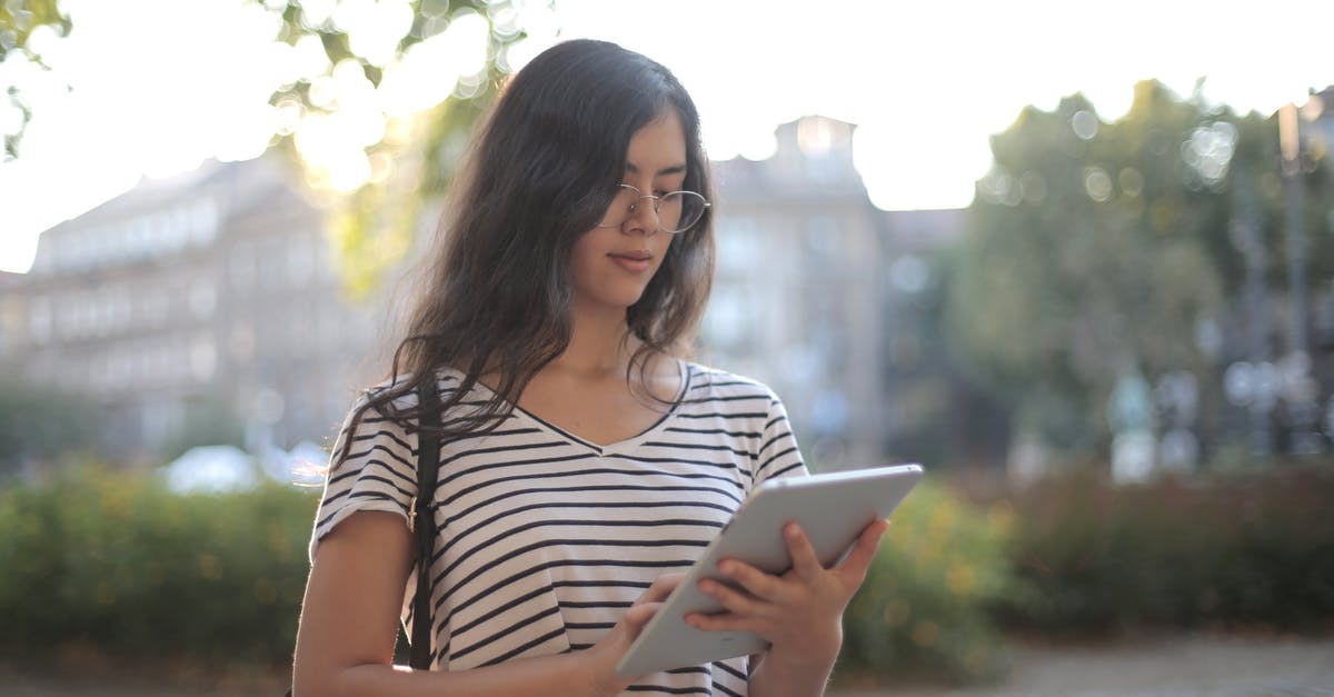 Are there any tool/sites I can use to plan my route? - Calm pensive female freelancer using digital tablet on street