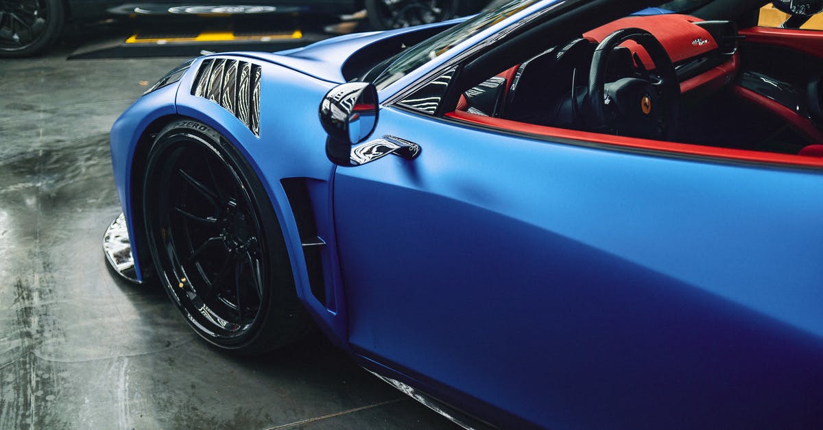 Are there any VIP Services at Nicaragua airport? - High angle of luxury blue sports car with red interior and curved details parked in modern garage