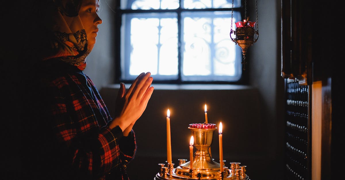 Are there any women-only places in the world? - Woman in Black and White Plaid Dress Shirt Holding Lighted Candles