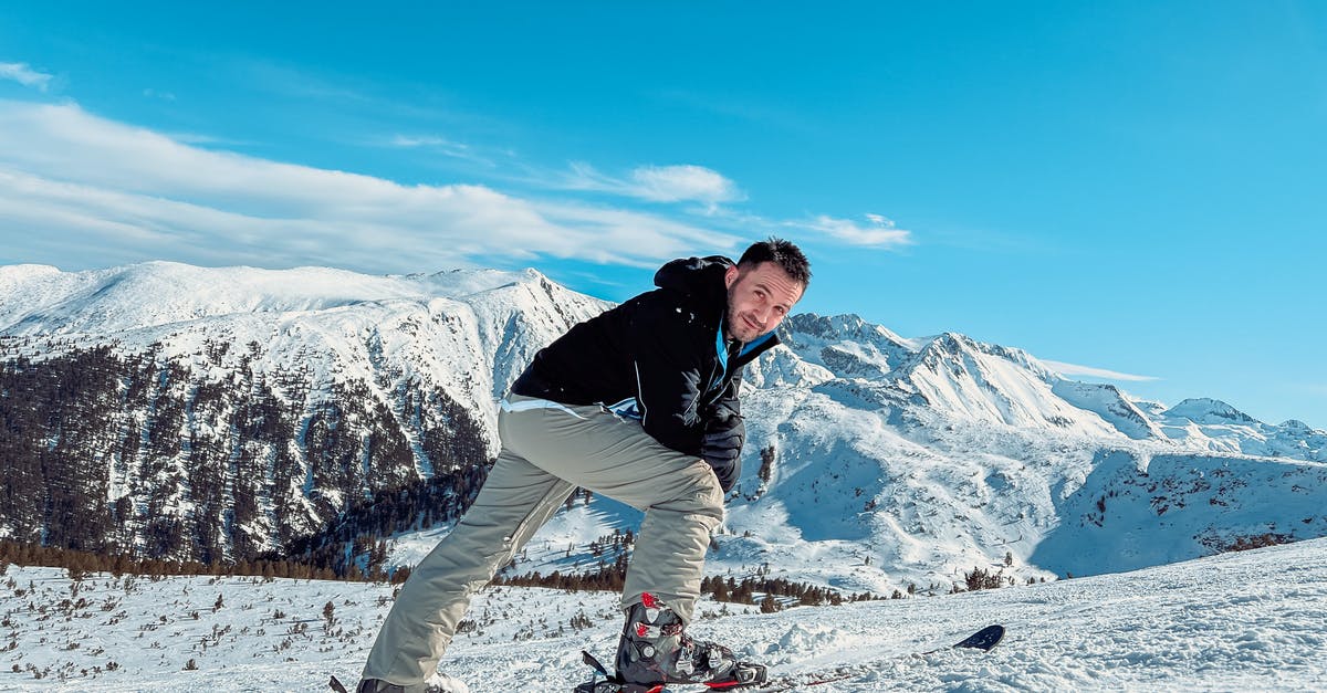 Are there area-wide ski passes in southern Poland? - Man Skiing on Snow Covered Mountain Area