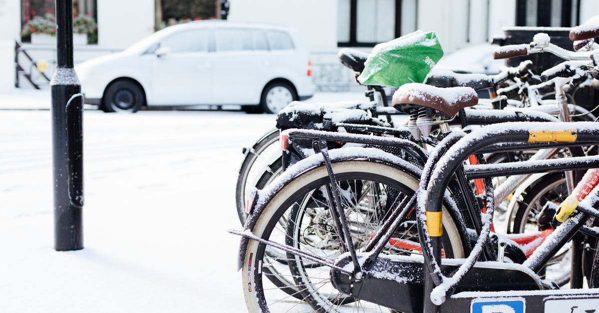 Are there bikes for rent in Stockholm? - Modern bicycles parked on street covered with snow on winter day in city district