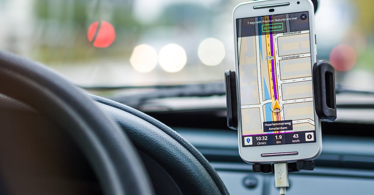 Are there cheap GPS or other navigator devices with downloadable maps for the whole world? - White Android Smartphone Inside Vehicle