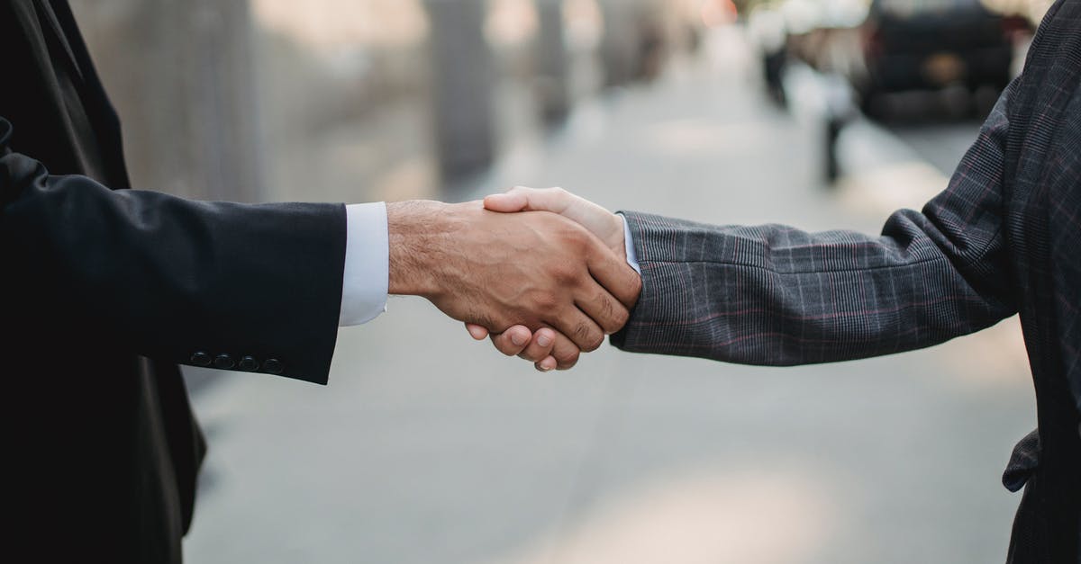 Are there countries where I shouldn't offer to shake hands with people of the opposite sex? [closed] - Close-up of Business People Shaking Hands