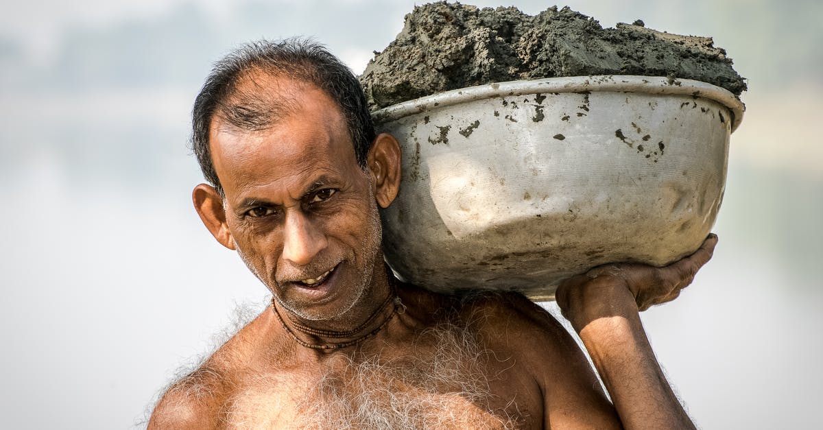 Are there crowd-sourced websites for travel bucket lists? - Man Carrying Bucket of Mud