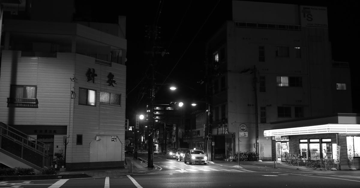 Are there cycling-friendly cities in Southeast Asia (except Singapore)? - Black and White Photo of a City Road at Night