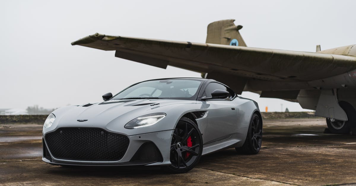 Are there kiosks at Malpensa Airport? - A Car Parked Beside airplane