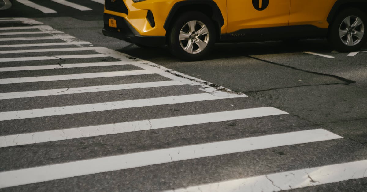 Are there less expensive sources for yellow-fever vaccinations? - Luxury yellow crossover taxi car on zebra crossing