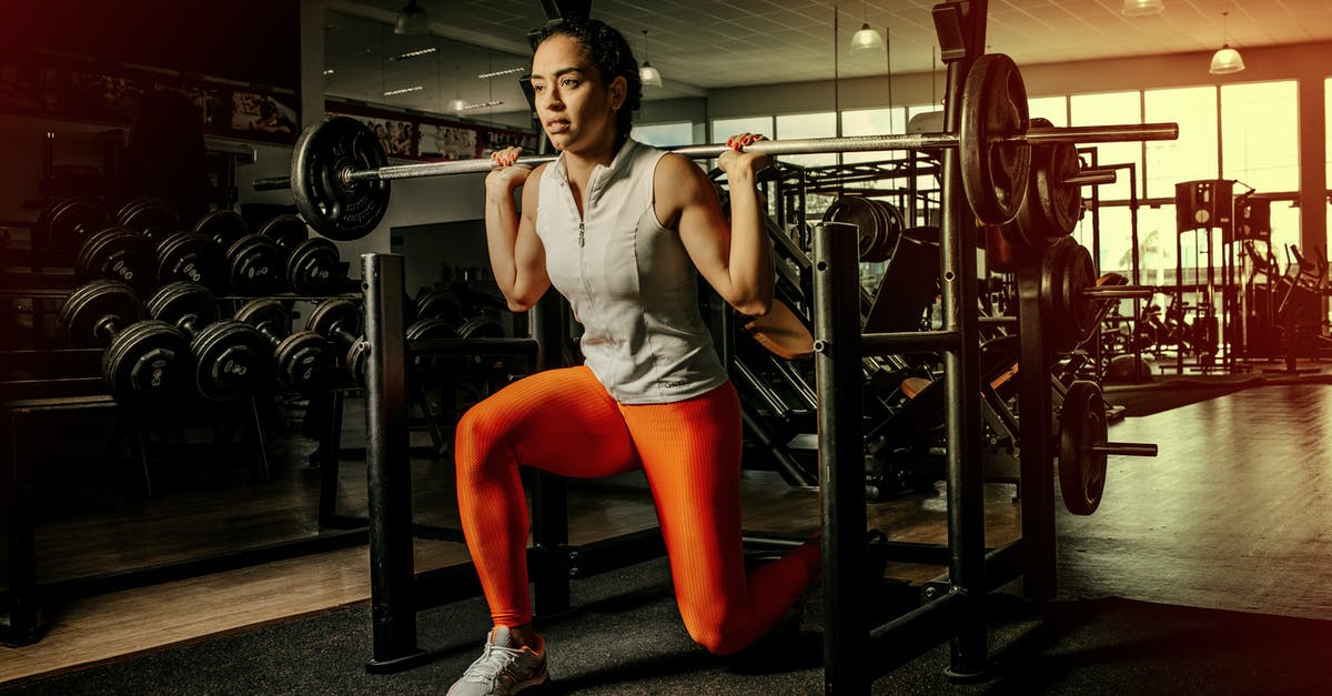 Are there metal clubs in London? - Woman Kneeling With Barbel on Shoulders