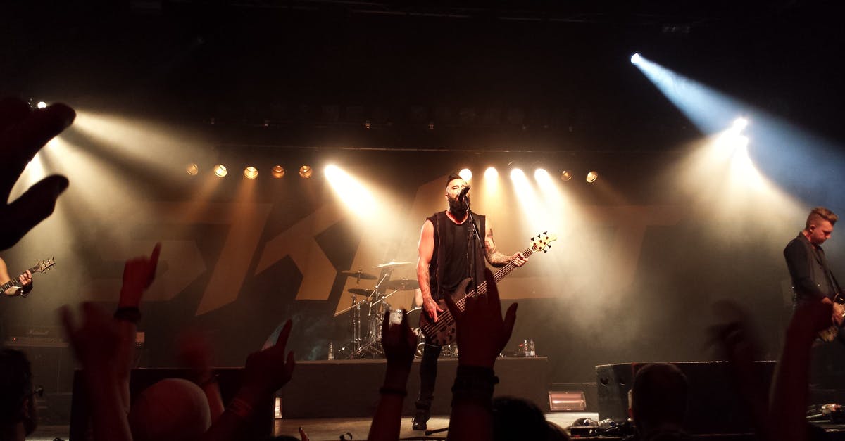 Are there metal clubs in London? - Person Playing Guitar on Stage