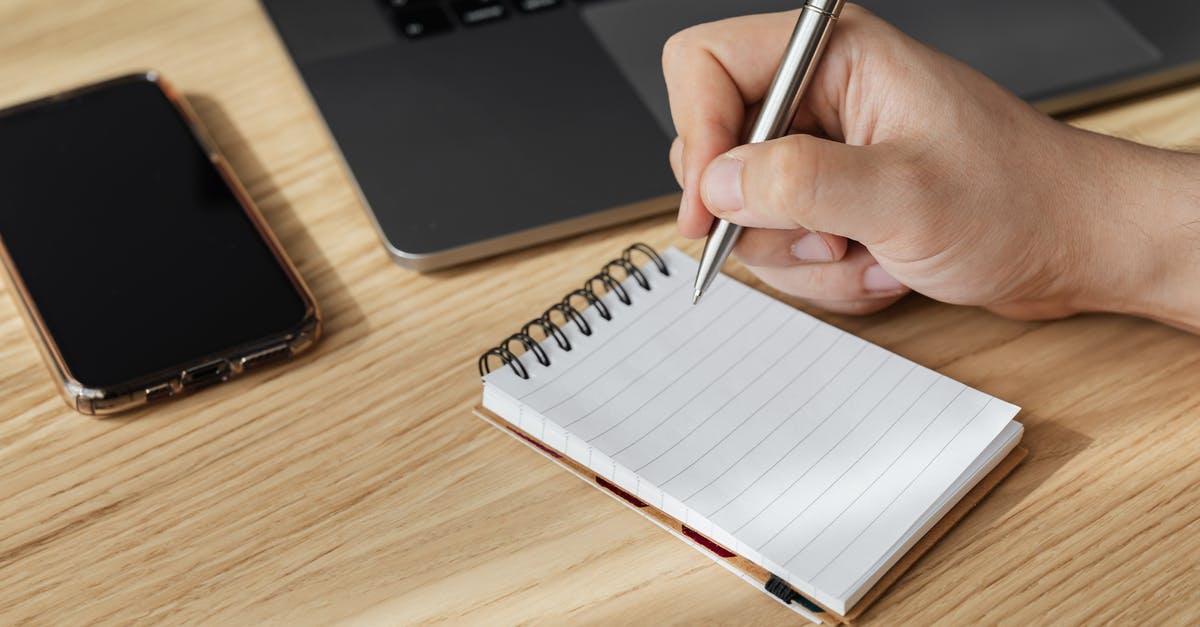 Are there organized surfing day trips from Bordeaux? - Crop person writing in notebook at workplace