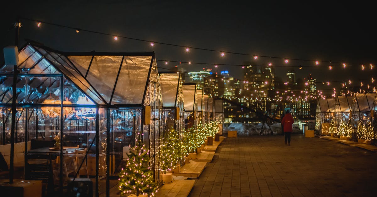 Are there public Midsummer's Eve events near Stockholm I could attend? - Illuminated festive street with glass cafe