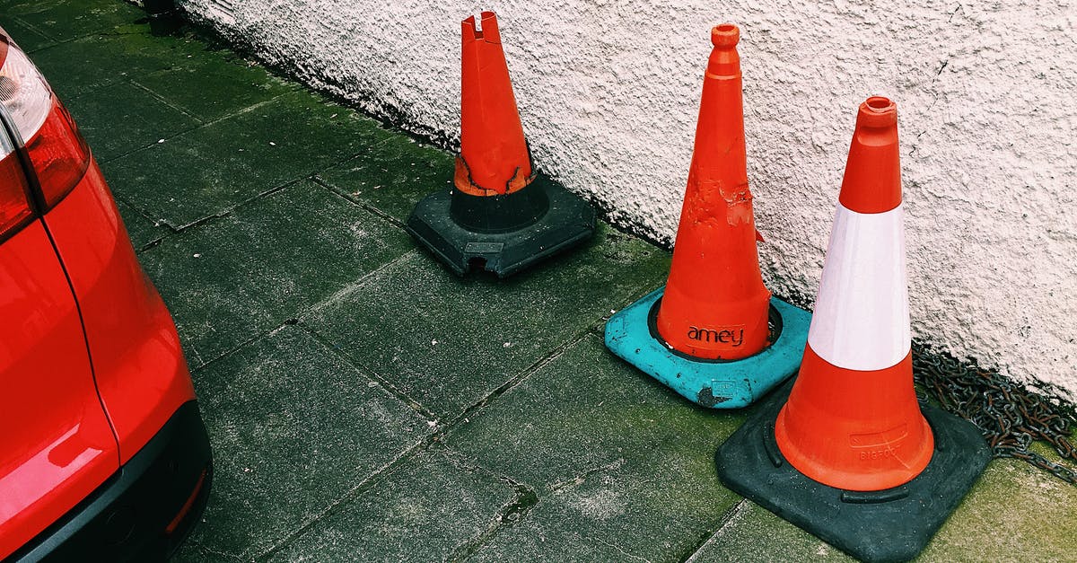 Are there red light districts in St. Petersburg or Moscow? - Traffic cones placed near car on road in city street