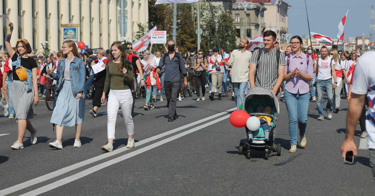 Are there walking tours (where you join a group) in Rotterdam? - A Family with Their Baby Joining a Protest