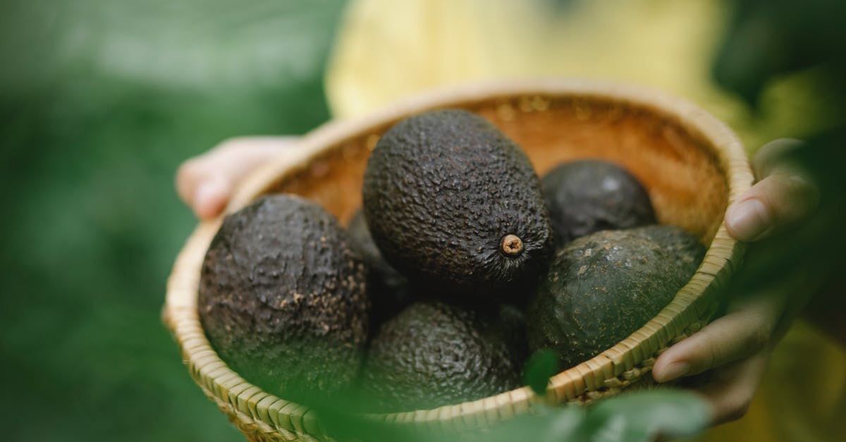 Are truffles (the edible fungi) allowed in carry on? - From above of crop anonymous person carrying wicker bowl full of fresh harvested avocados