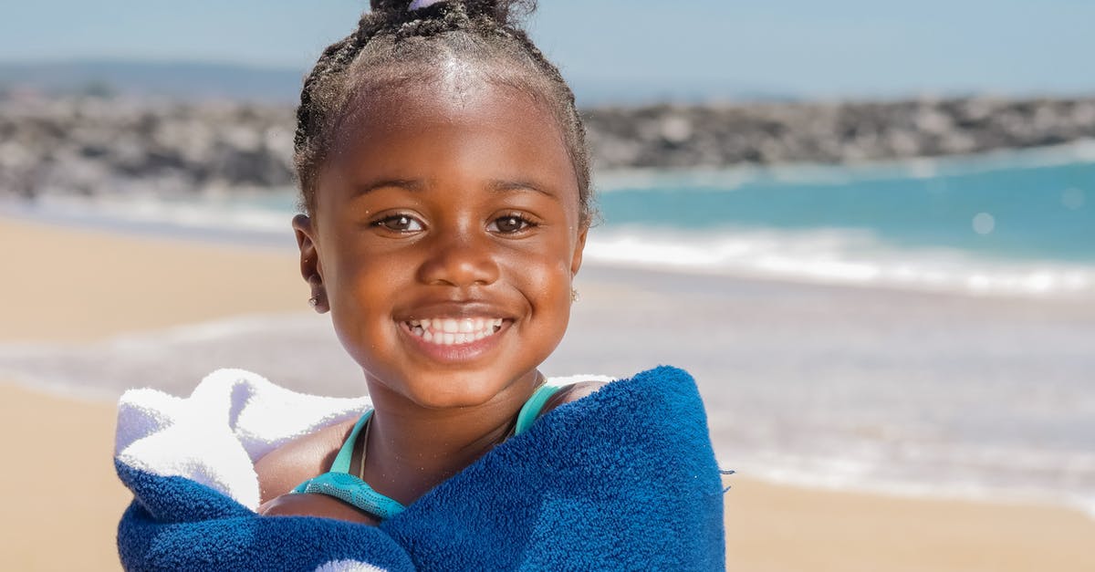 Are Turkey Black Sea beaches suitable for bathing in summer? - Smiling Girl Wrapped in Blue and White Towel