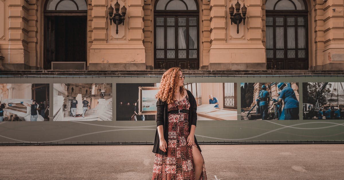 Are women required to wear skirts to get into some tourist sites? - Woman Standing in Front of Building