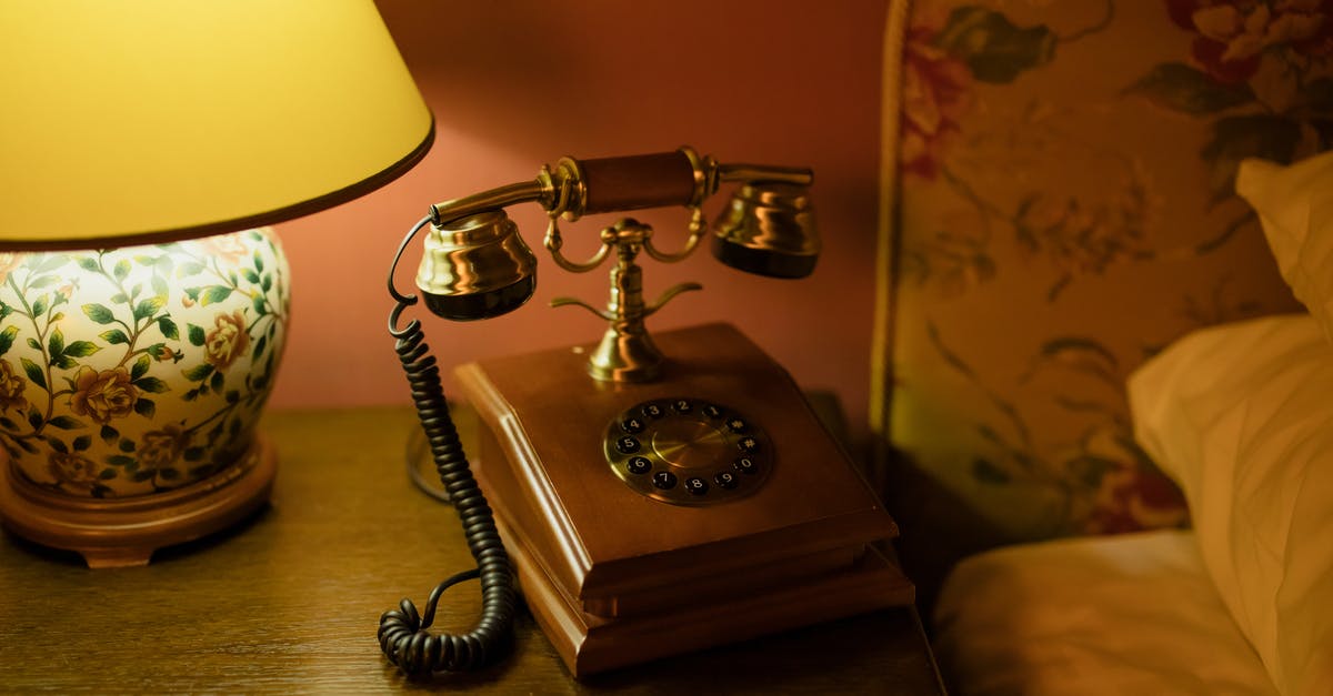 Arriving in hotel after 6 pm after announcing via telephone - Vintage Telephone Beside the Bed