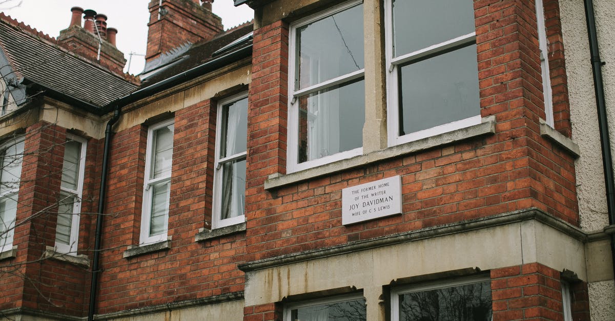 Article 10 residence card, visiting UK via Eurostar - Brown Brick Building With White Wooden Framed Glass Window