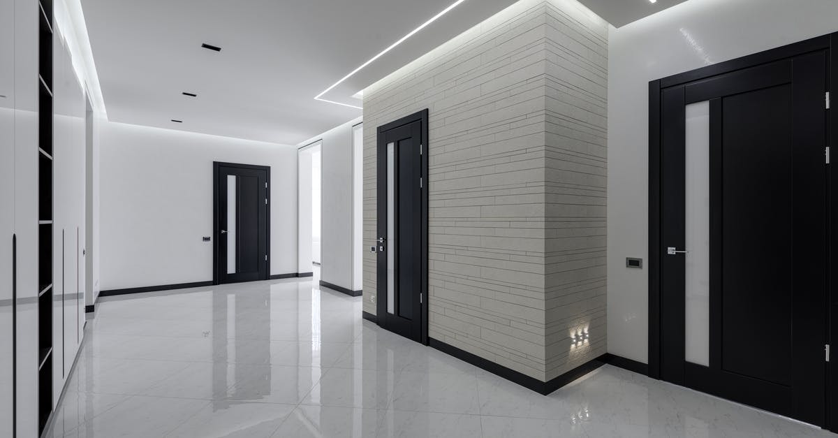 As a Russian resident, do I require an exit visa? - Modern spacious corridor with white walls and floor and black doors and ceiling decorated with LED lights